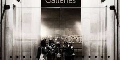 The glass doors of the Parthenon Galleries in The British Museum, looking through to the sculptures