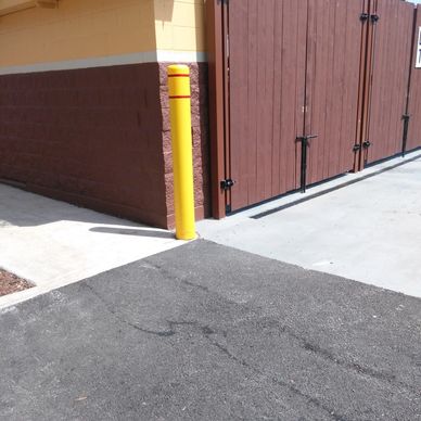 Fabricated and painted bollard for trash enclosure.