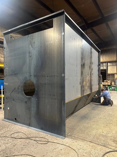 Custom fabrication of an oil pit enclosure.