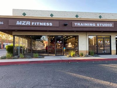 Exterior view of MZR Fitness Training Studio storefront with glass doors and windows.