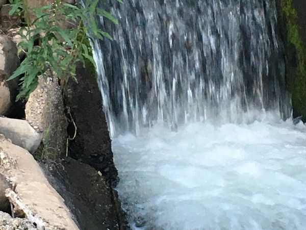 Water flowing over a small dam