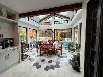 Bright dining area with skylights and hexagonal floor tiles.
