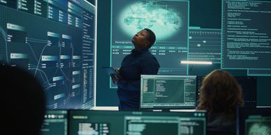 A cybersecurity expert analyzes data on multiple digital screens in a high-tech control room.