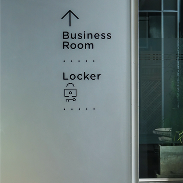 Directional sign to Business Room and Locker in a modern office.