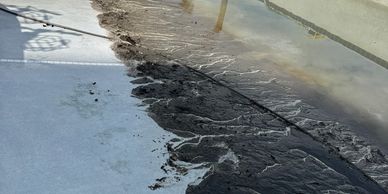 Empty pool partially filled with dirty water and debris.