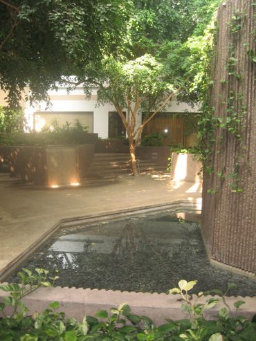 Tranquil courtyard with a water feature and lush greenery.