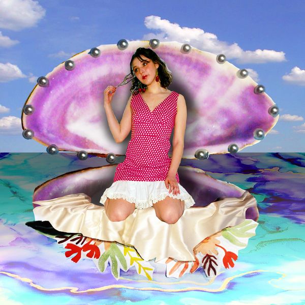 Woman in a pink dress sitting inside a giant, opened purple pearl shell.