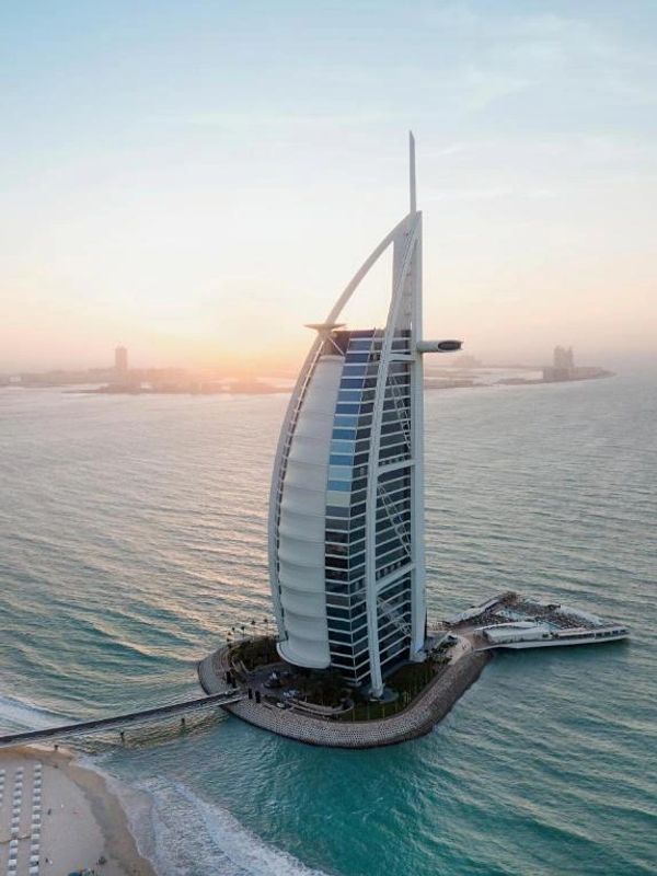 Burj Al Arab hotel on its artificial island during sunset in Dubai.