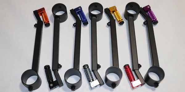 Six black metal mounts with colored grips in red, blue, gold, purple, and black.