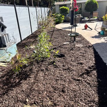 Put mulch down in client backyard 