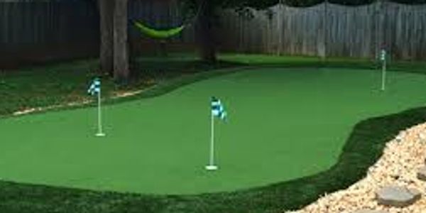 Artificial turf installed in a back yard with engineered golf turf installed in the middle. 