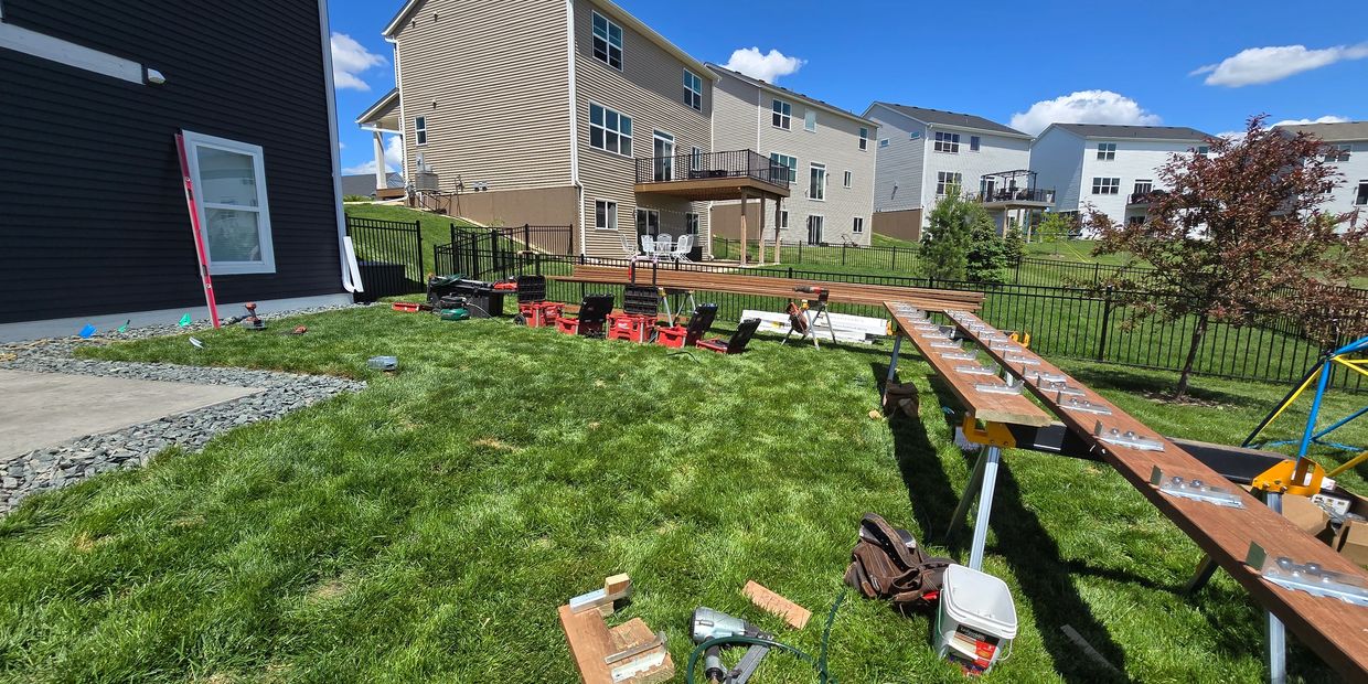 Backyard construction with tools and wood on a sunny day.