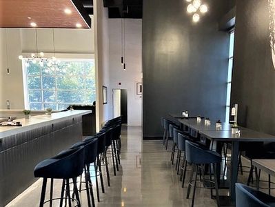 Modern dining area with sleek chairs and tables in a minimalist setting.