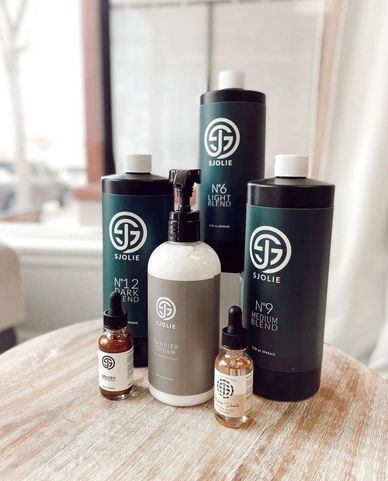 Sjoile branded hair care products arranged on a wooden table.