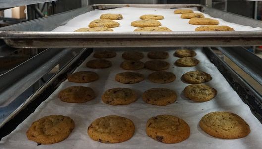 Freshly baked cookies on a cooling rack.