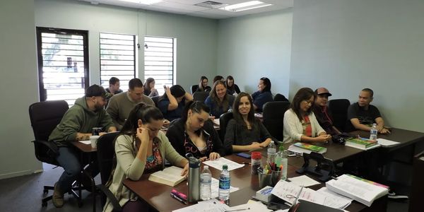 Students writing notes and having discussions in class