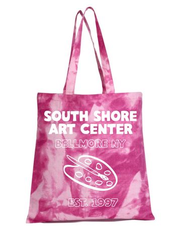 Pink tie-dye tote bag with art center logo and text.
