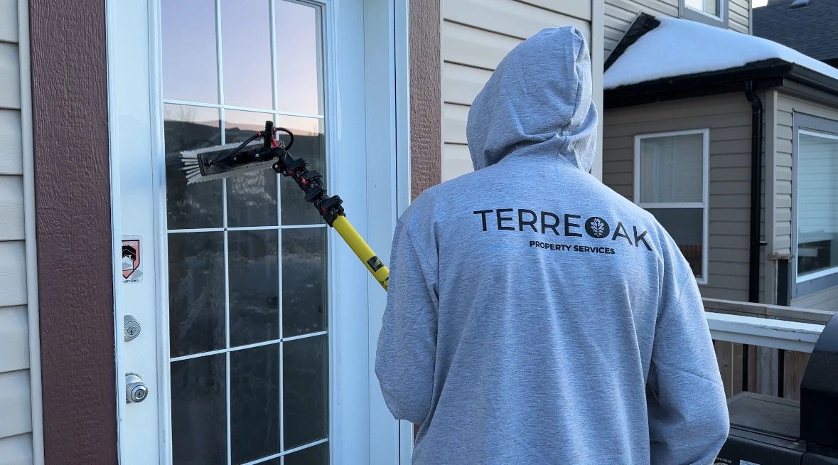 Person cleaning Back door window with tucker rivals three stage cart.