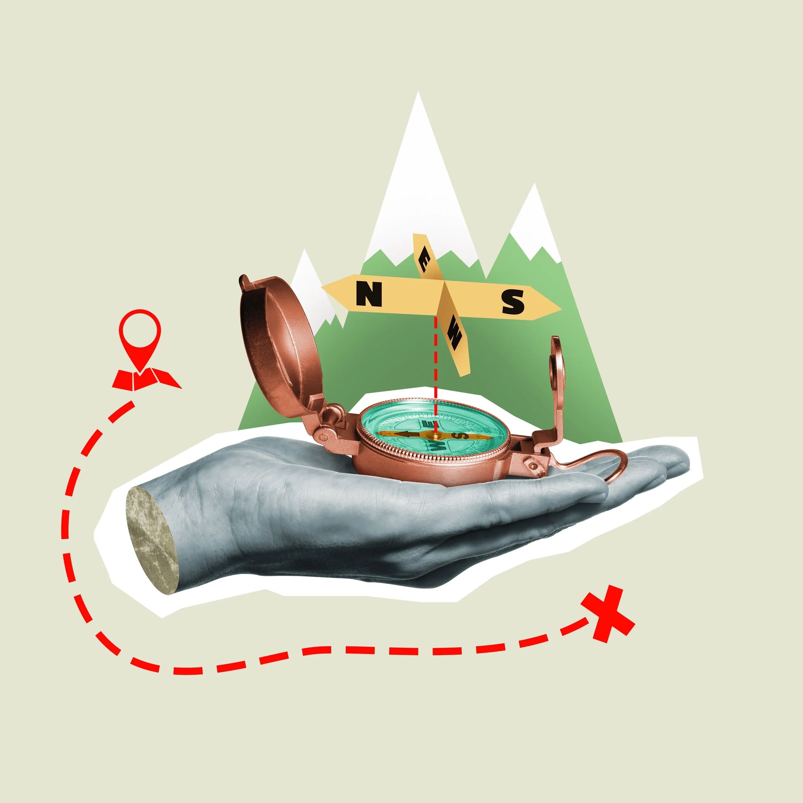 A hand holding a compass with mountains and a directional sign in the background.