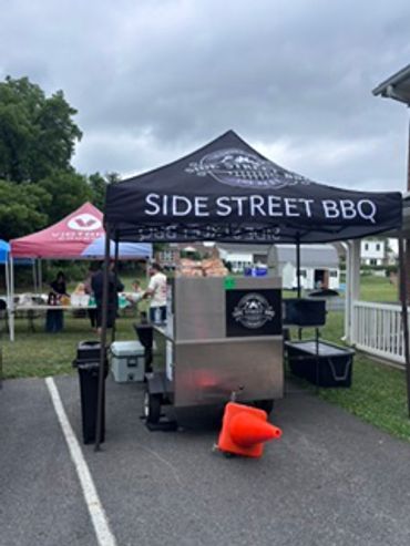Side Street BBQ food stand setup outdoors.