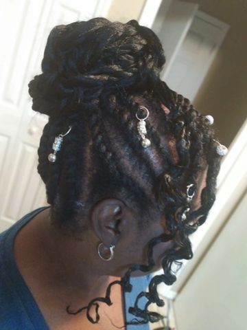 Flat twist styled into an updo with ornaments created by Lady E