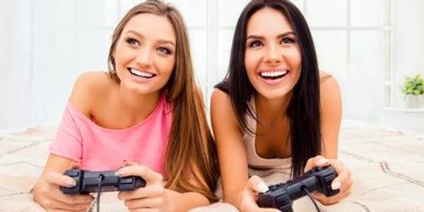 Sexy girls in bed playing video games
