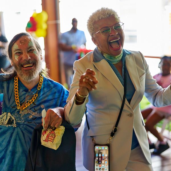 Two people smiling and laughing at a fun-filled CRi event.