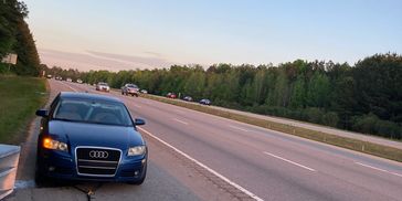 Towing a broken down Audi off the side of the highway