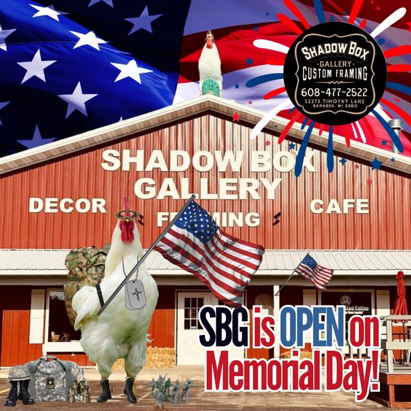 Patriotic chicken with American flags in front of Shadow Box Gallery on Memorial Day.