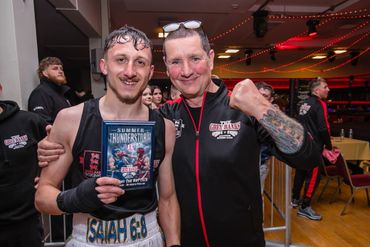 Two men celebrating a boxing victory with a DVD in hand.