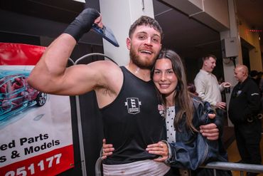 Two friends smiling and posing happily at an event.