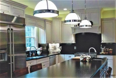 kitchen full height backsplashes, kitchen with bright green walls, custom wood hood