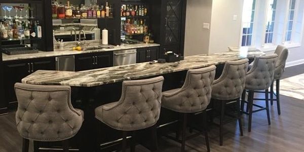 Dark stained bar, glass shelving, bar with island, granite countertops in bar, x mullion doors