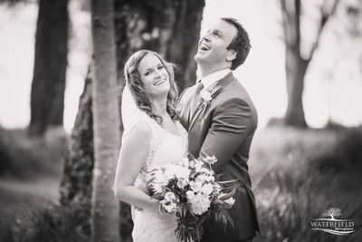 Married couple hugging and laughing.