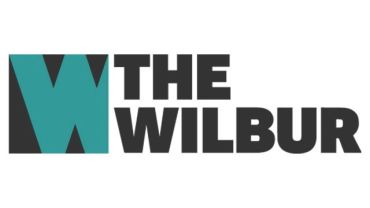 Logo of The Wilbur featuring a stylized W.