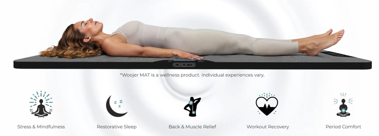 Woman resting on a wellness mat promoting relaxation and recovery.