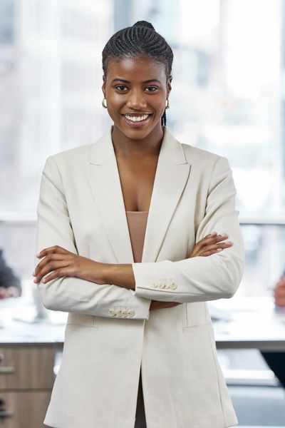 Black woman wearing a cream suit jacket