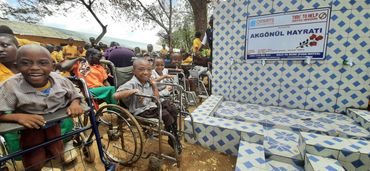Disabled students in Kenya celebrating at the launch of a new borehole dug by the Omeriye foundation