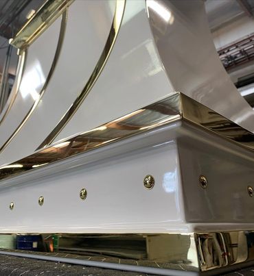Hood #9234. Steel body with curved detail and white powder coat finish. Top decorative brass band wi