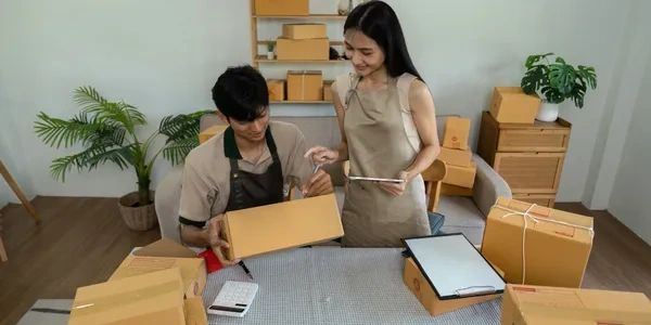 Man and woman working from home with a dropshipping business.