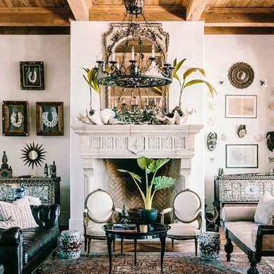 Elegant living room with vintage decor and a grand fireplace.