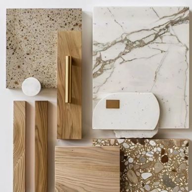 Elegant natural stone and wood samples with gold accents arranged neatly.