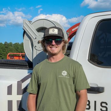 Jacob Lankford and a Bishop's Land Service work truck.