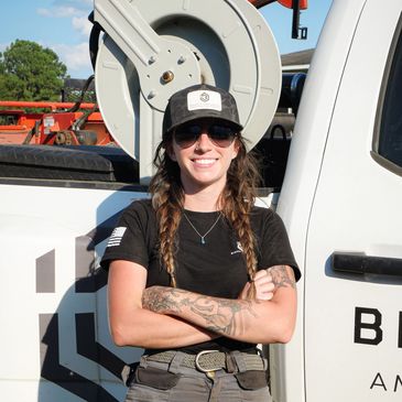 Lily Heath and a Bishop's Land Service work truck.