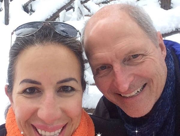 Smiling couple outdoors in snowy winter setting.