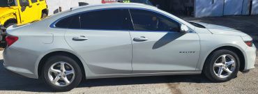 Silver Chevrolet Malibu car parked outside.
