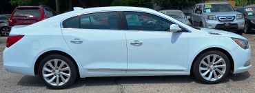 Side view of a white sedan car.