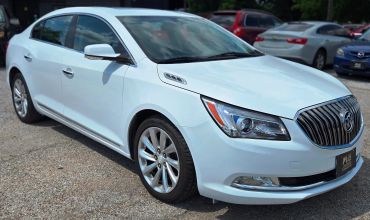 White luxury sedan parked outdoors.