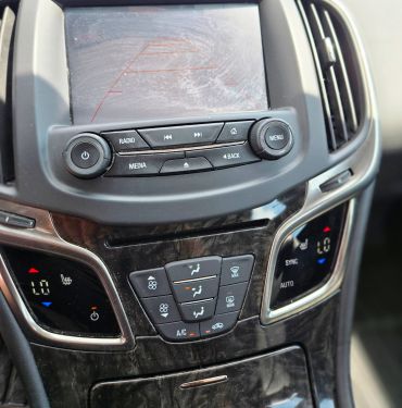 Car dashboard with climate control and media buttons.
