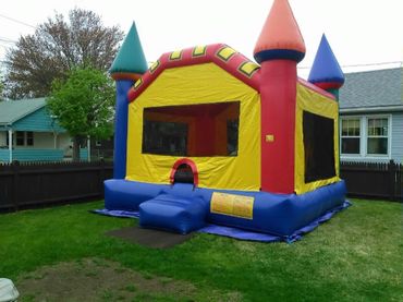 Colorful inflatable bounce house in a backyard.